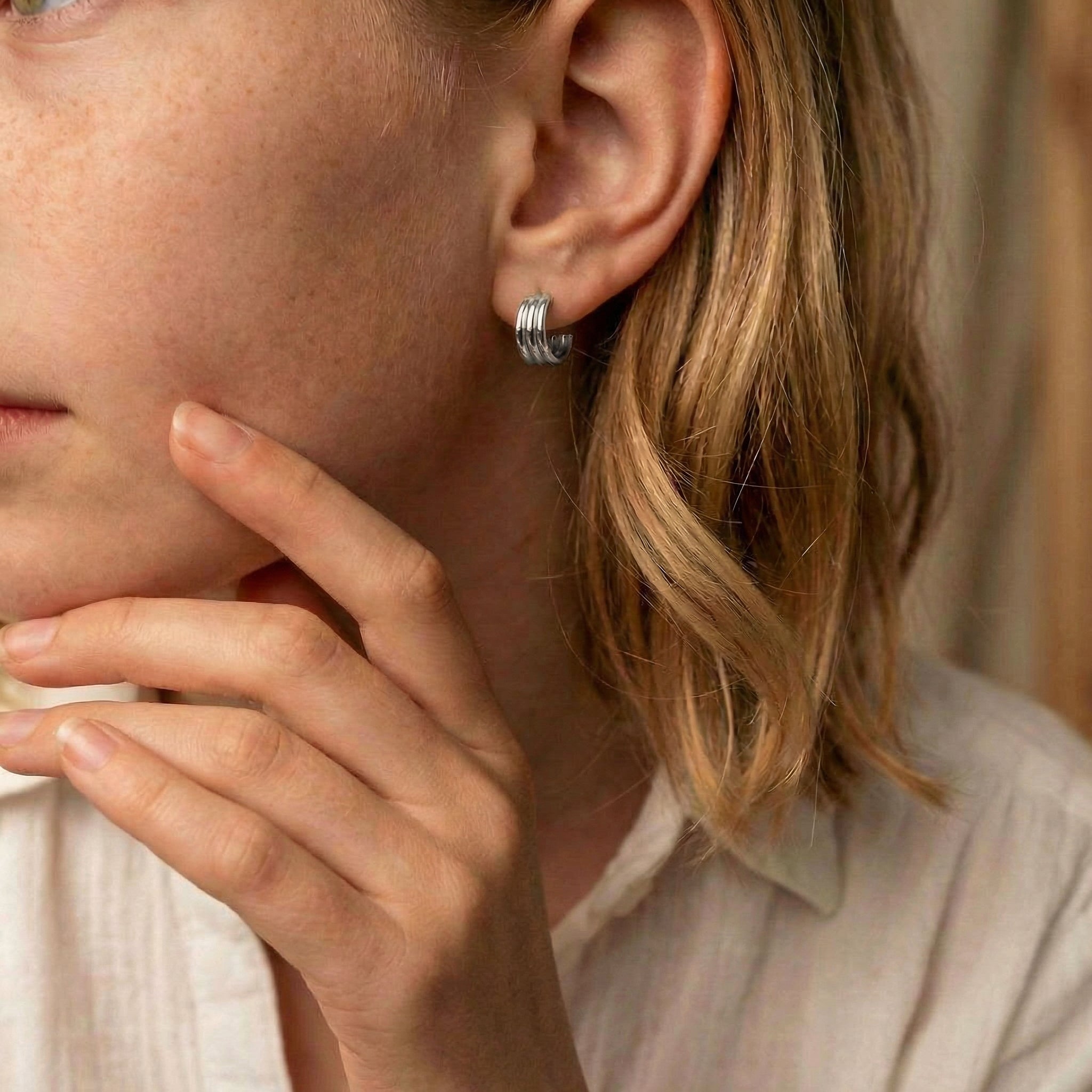 Hoop earrings silver earring worn on model with freckles