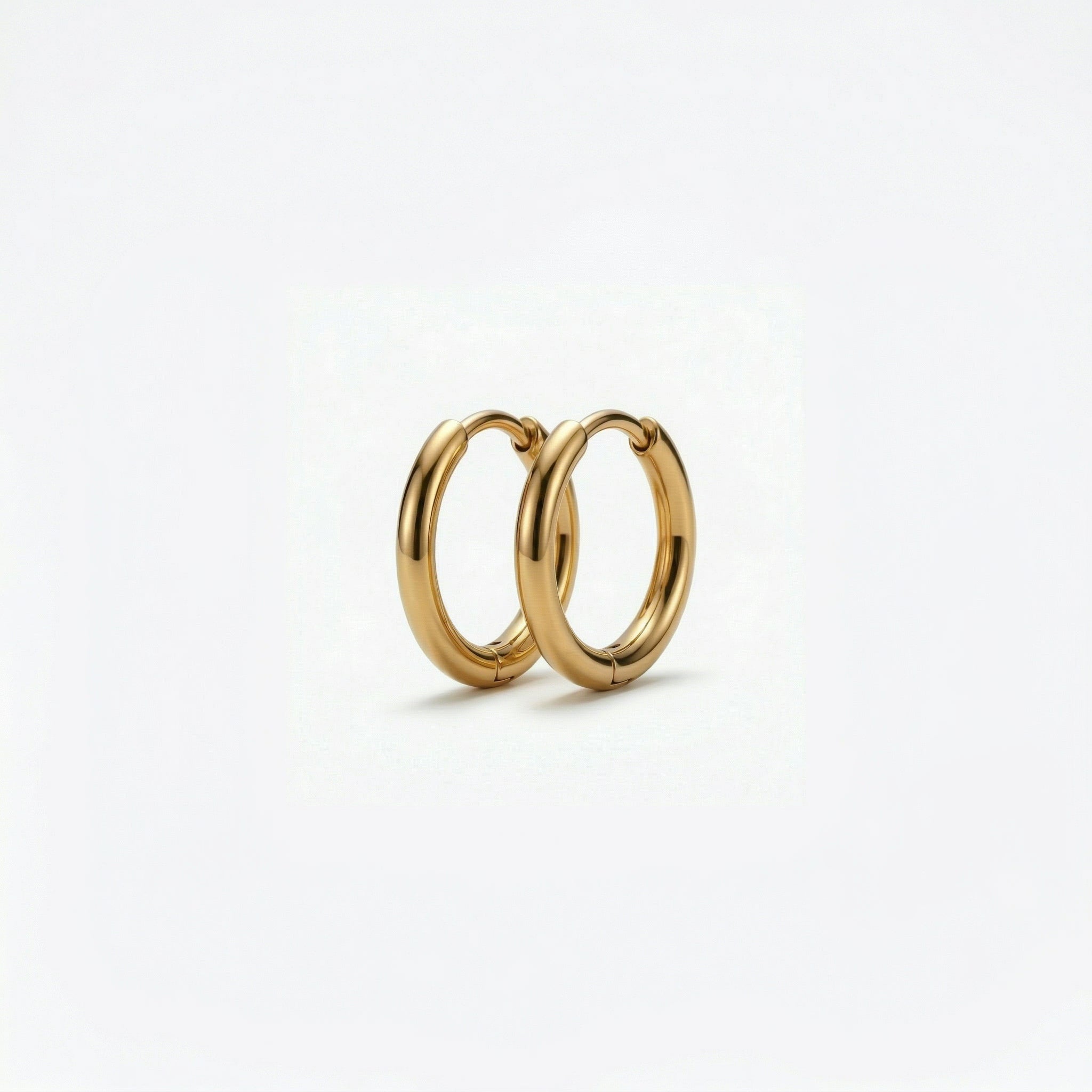 Gold-plated hoop earrings on white
