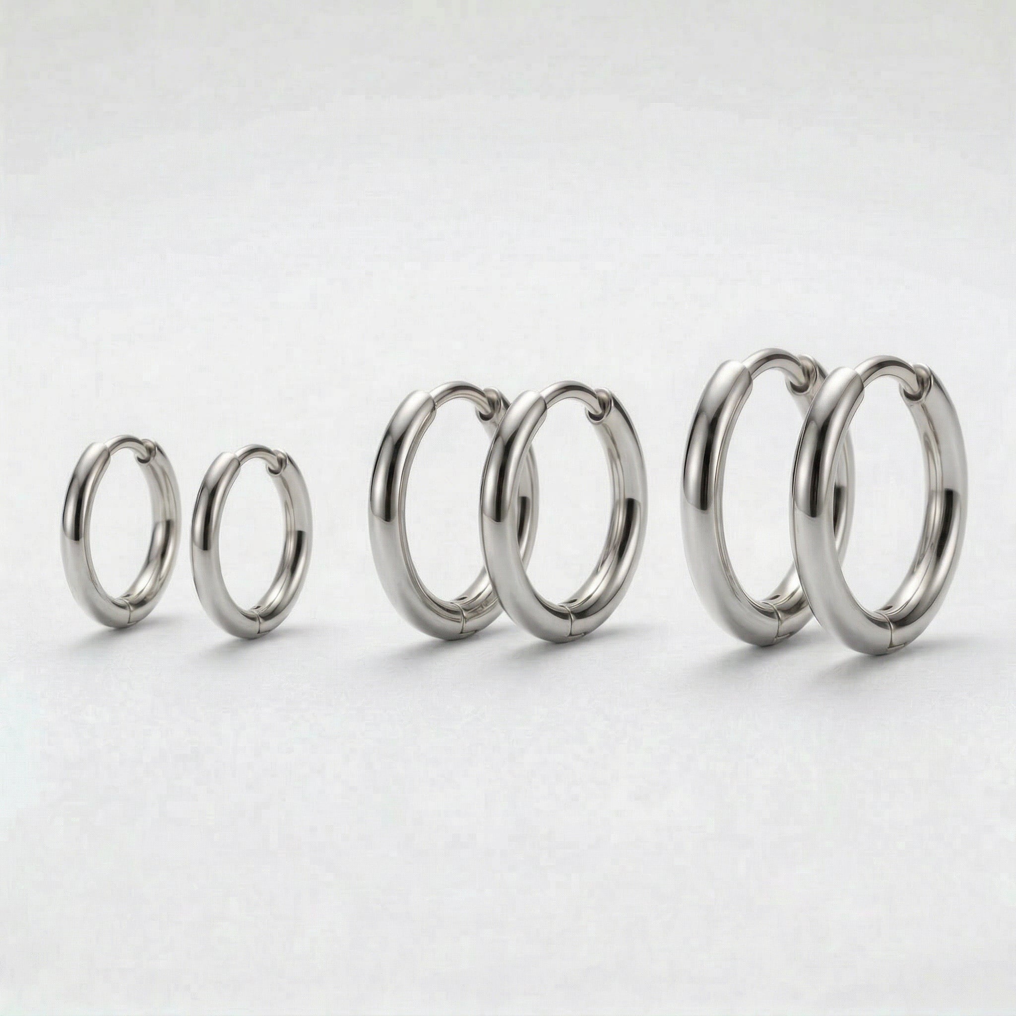 Three pairs of silver hoops in varying sizes