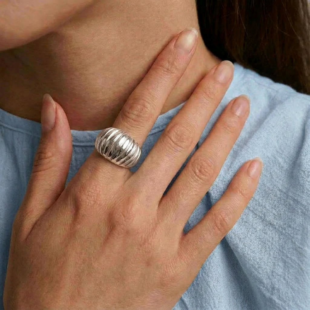 Silver ring worn on hand with blue top