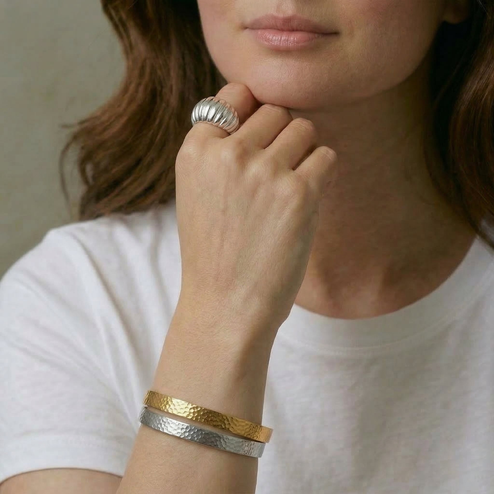 Silver ring worn on hand with bracelets