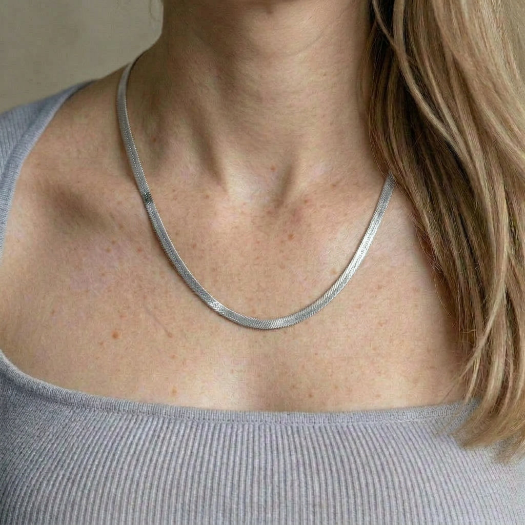 Silver necklace worn on model's neck