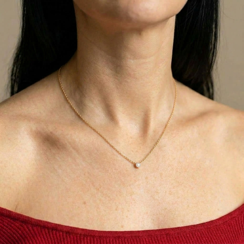 Gold-plated necklace on model wearing red top