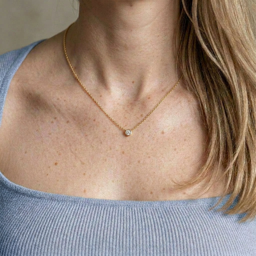 Gold-plated necklace on model wearing blue top