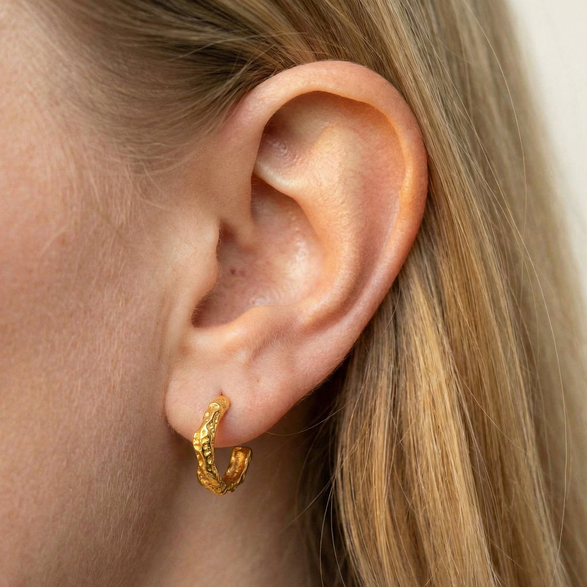 Hoop earrings gold-plated earring worn on ear with blonde hair