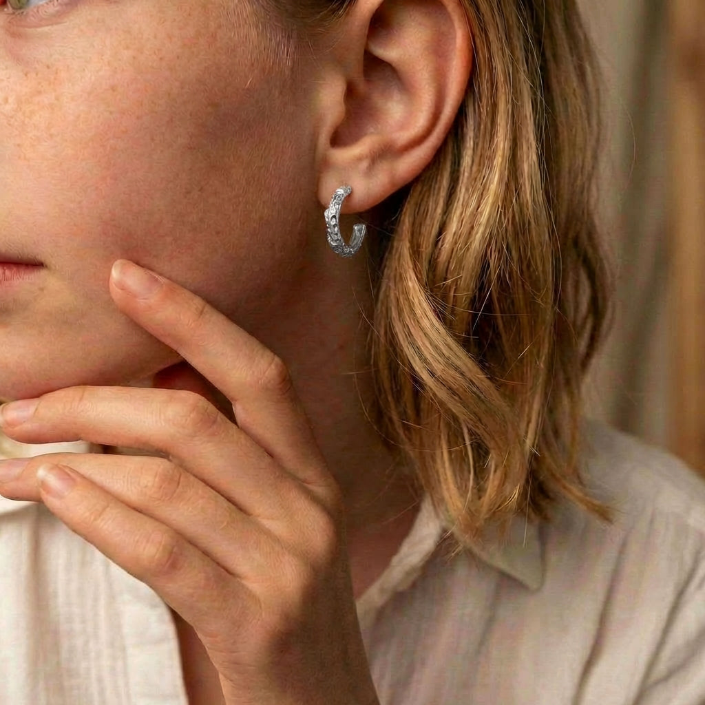 Hoop earrings silver earring worn on model's ear