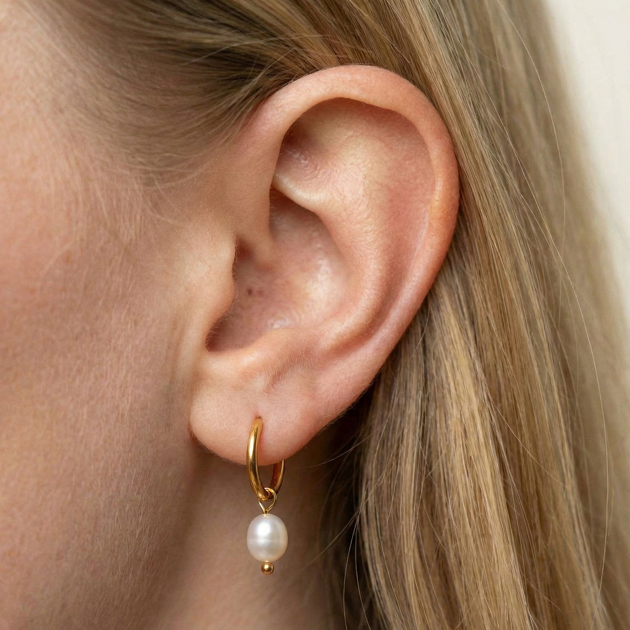 Pearl hoop earrings gold-plated earring worn on ear with blonde hair