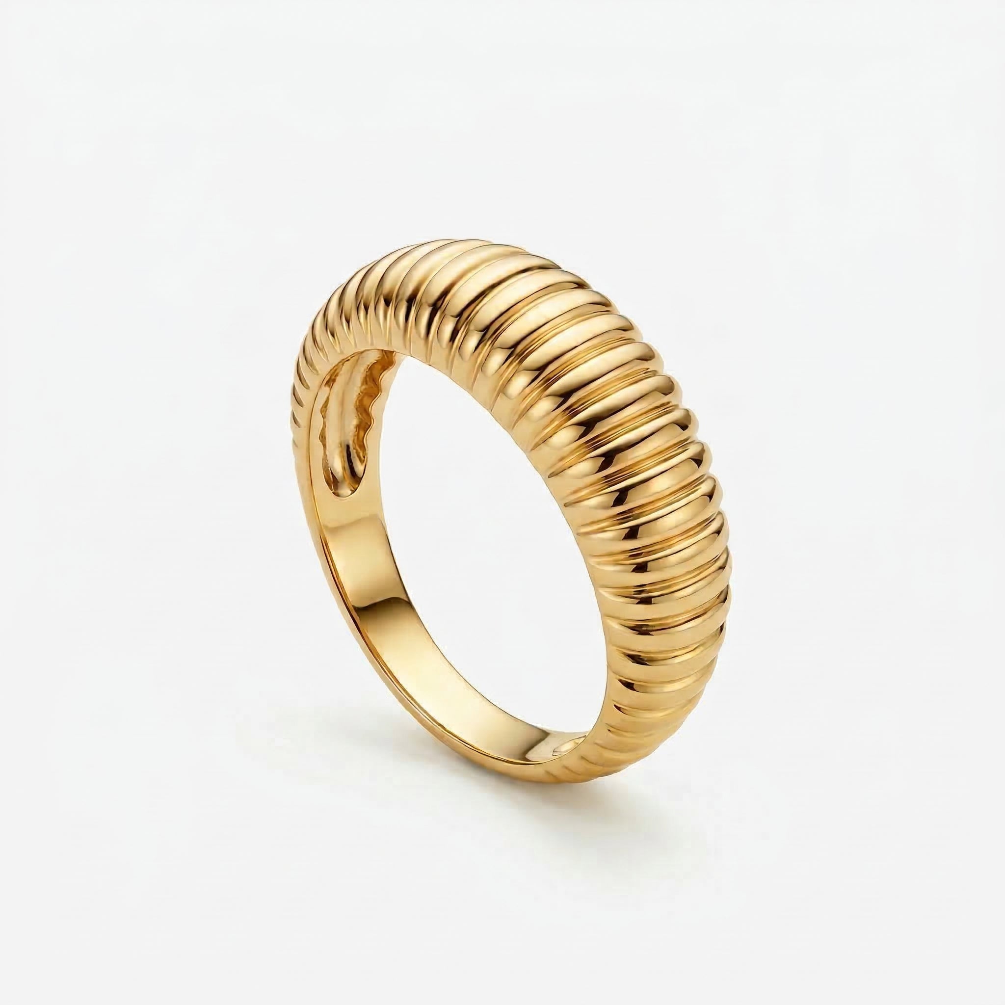 Gold-plated ribbed dome ring on white background