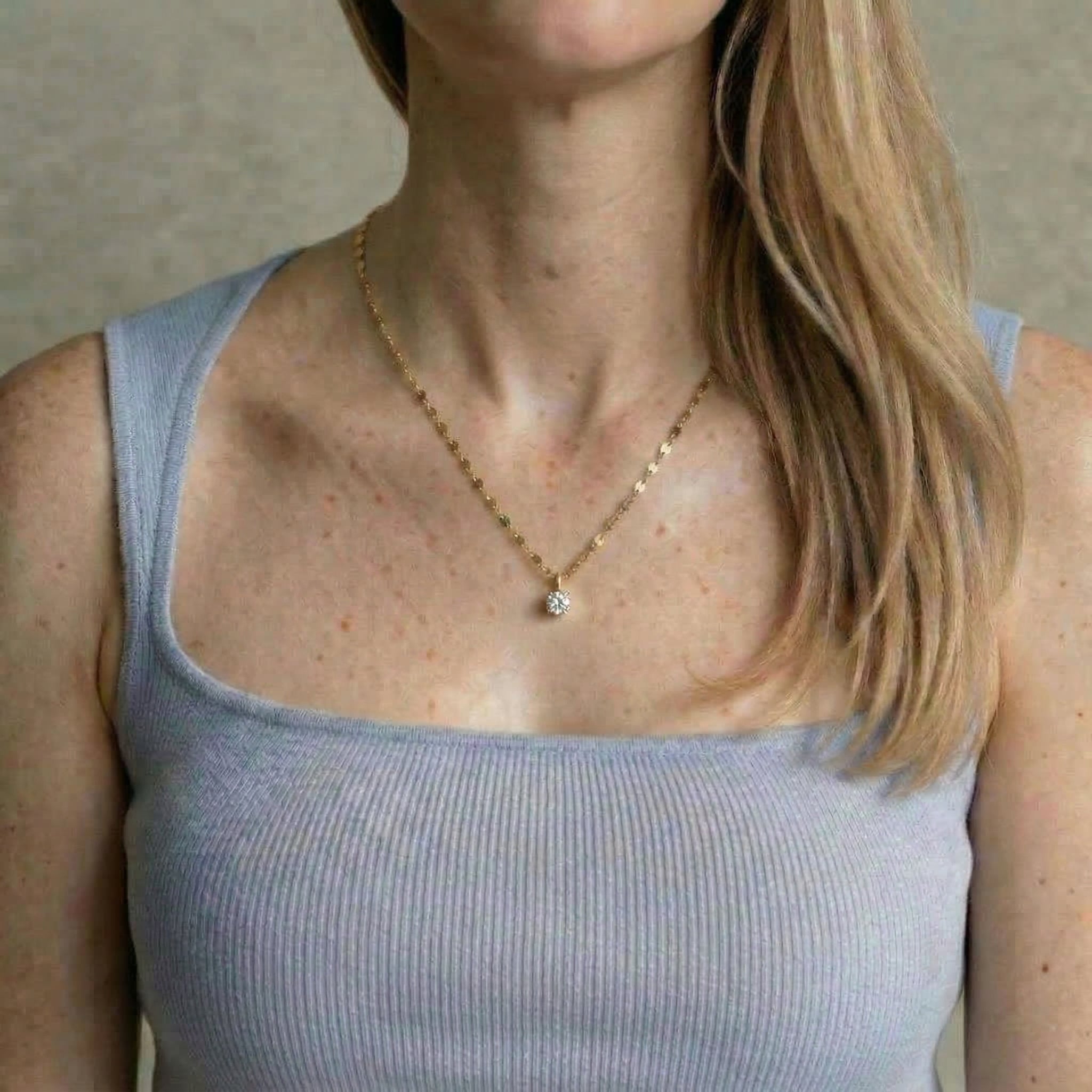 Gold-plated necklace worn with grey top