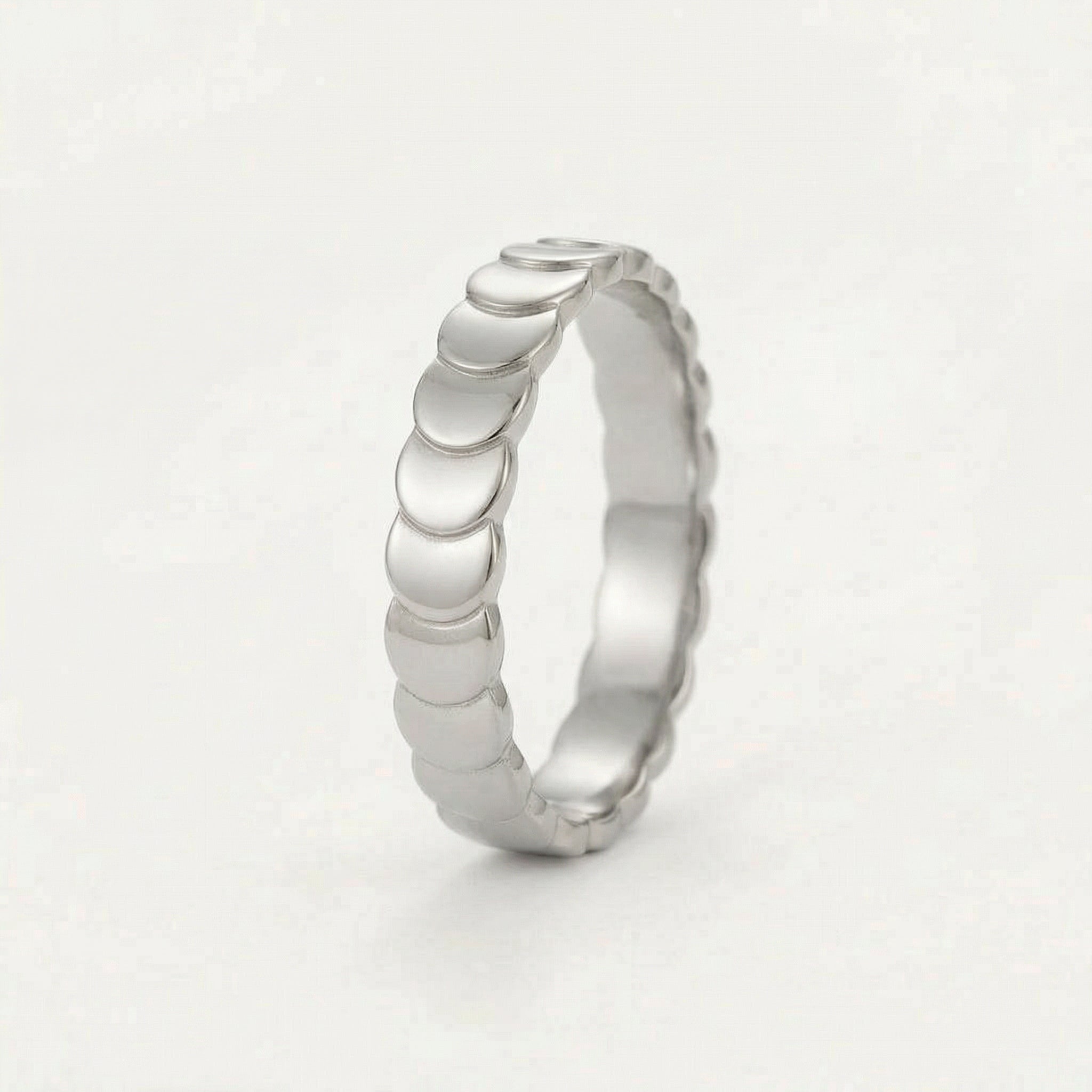 Side view of silver scalloped ring