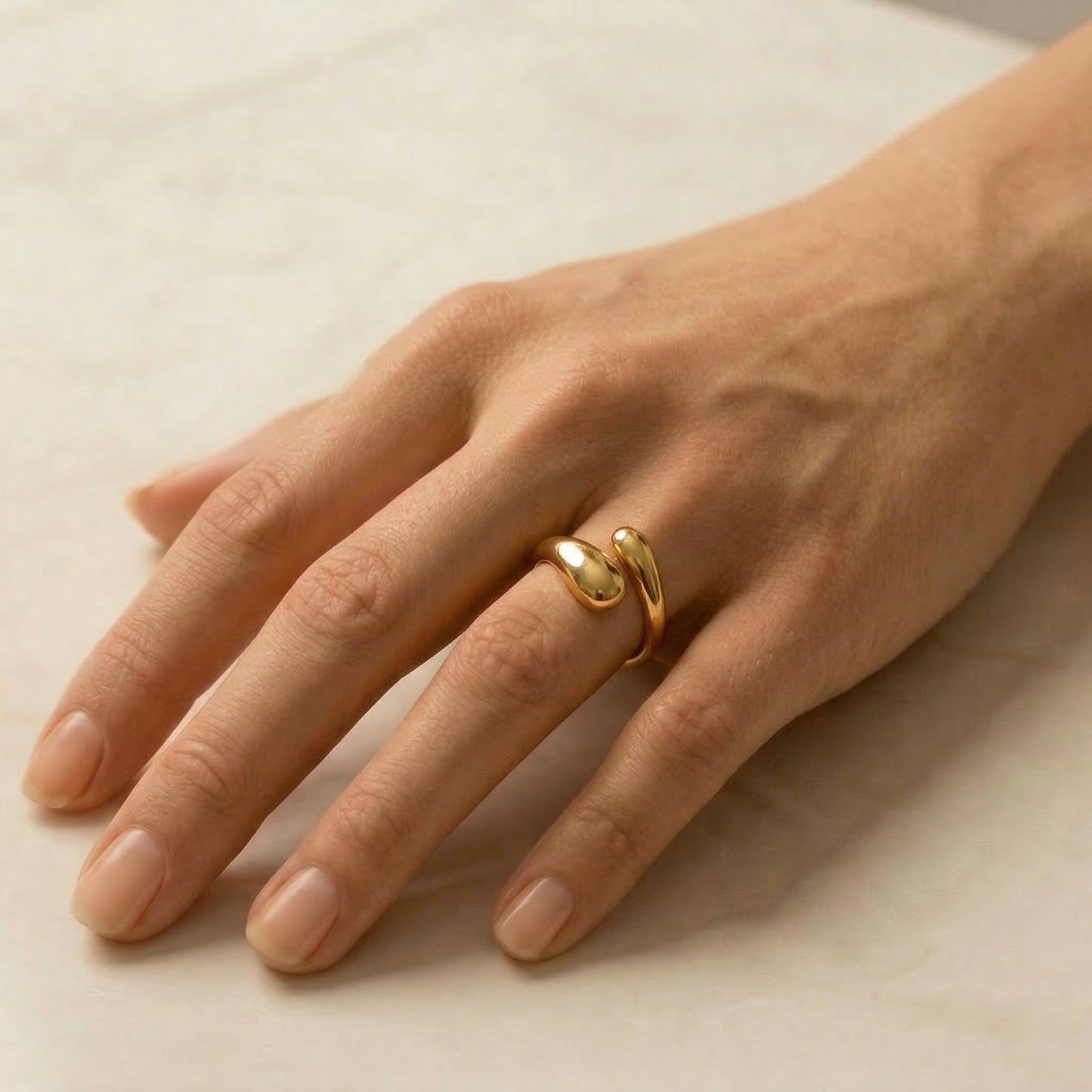 Gold-plated ring worn on hand, top view