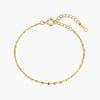 Gold-plated bracelet with flat, round, faceted links and a lobster clasp with an extender chain.