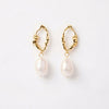 Gold-plated earrings with organic-shaped hoops and dangling baroque pearls on a white background.