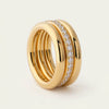 Gold stackable ring with three plain bands and one diamond-encrusted band in the center.