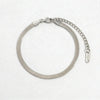 Silver herringbone chain bracelet with lobster clasp and extender chain, featuring an 18K tag.