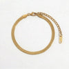 Gold herringbone chain anklet with lobster clasp and extender chain, featuring an "18K" tag.