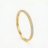 Gold band ring with a row of small, clear crystals along the top, and "S925 PRSML" engraved on the side.