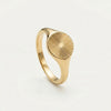 Gold signet ring with an oval face featuring a sunburst design of radiating lines.