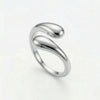 Silver-tone ring with two teardrop-shaped ends that twist around each other, forming an open band.