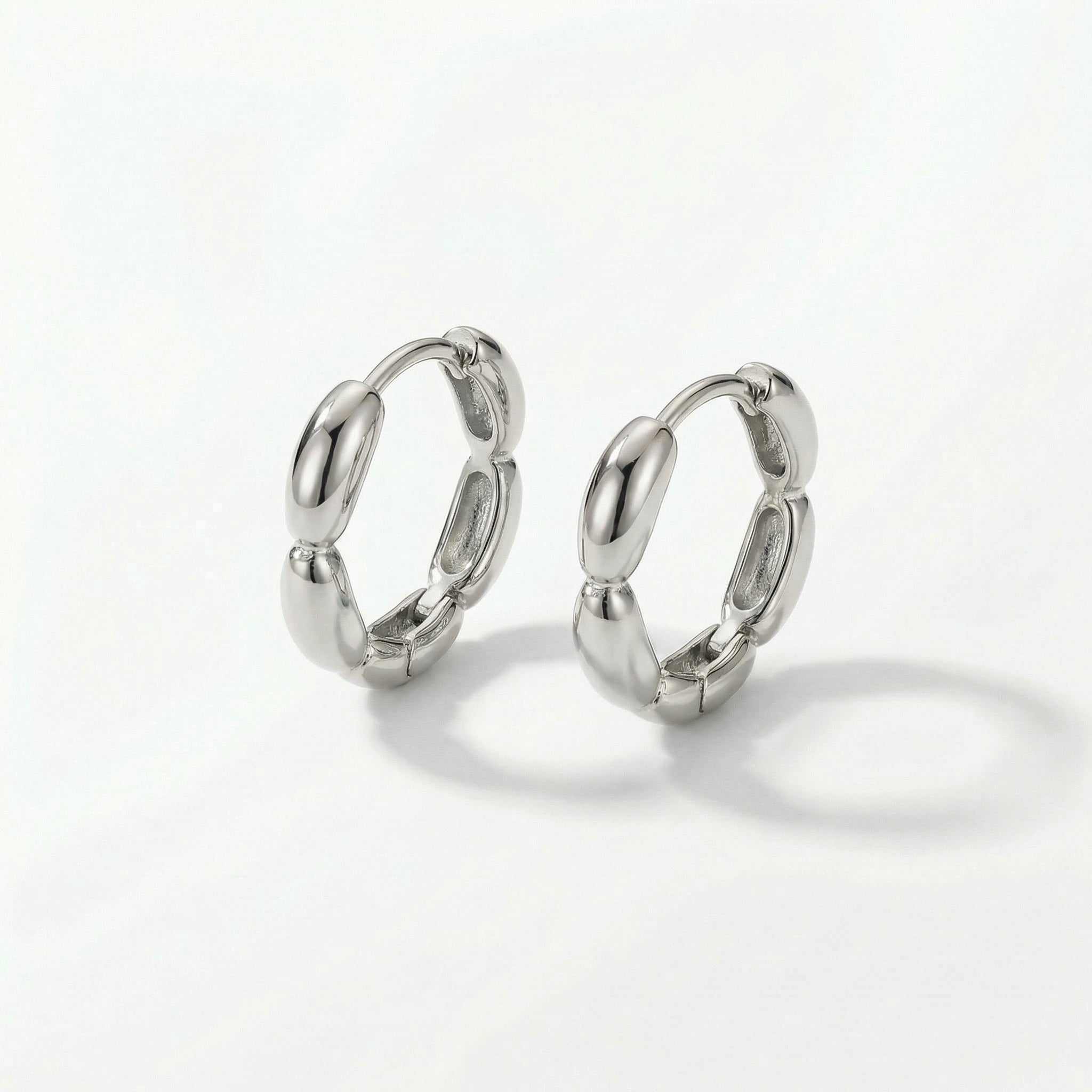 Silver huggie hoops on white