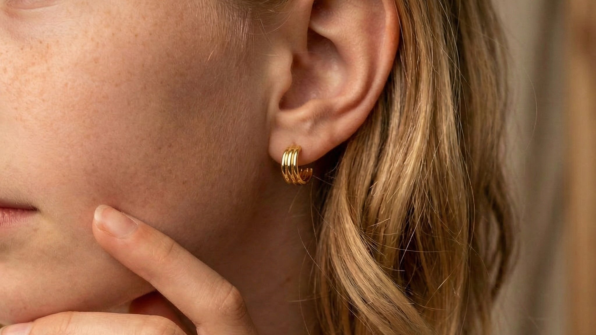 Hoop earrings gold-plated earring worn on a model's ear