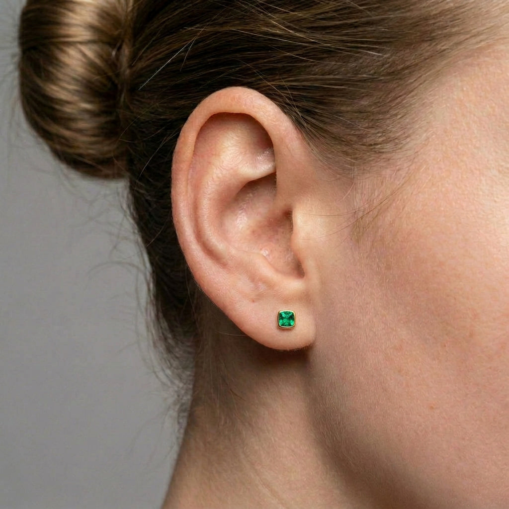 Crystal stud earrings gold-plated earring worn on a model's ear
