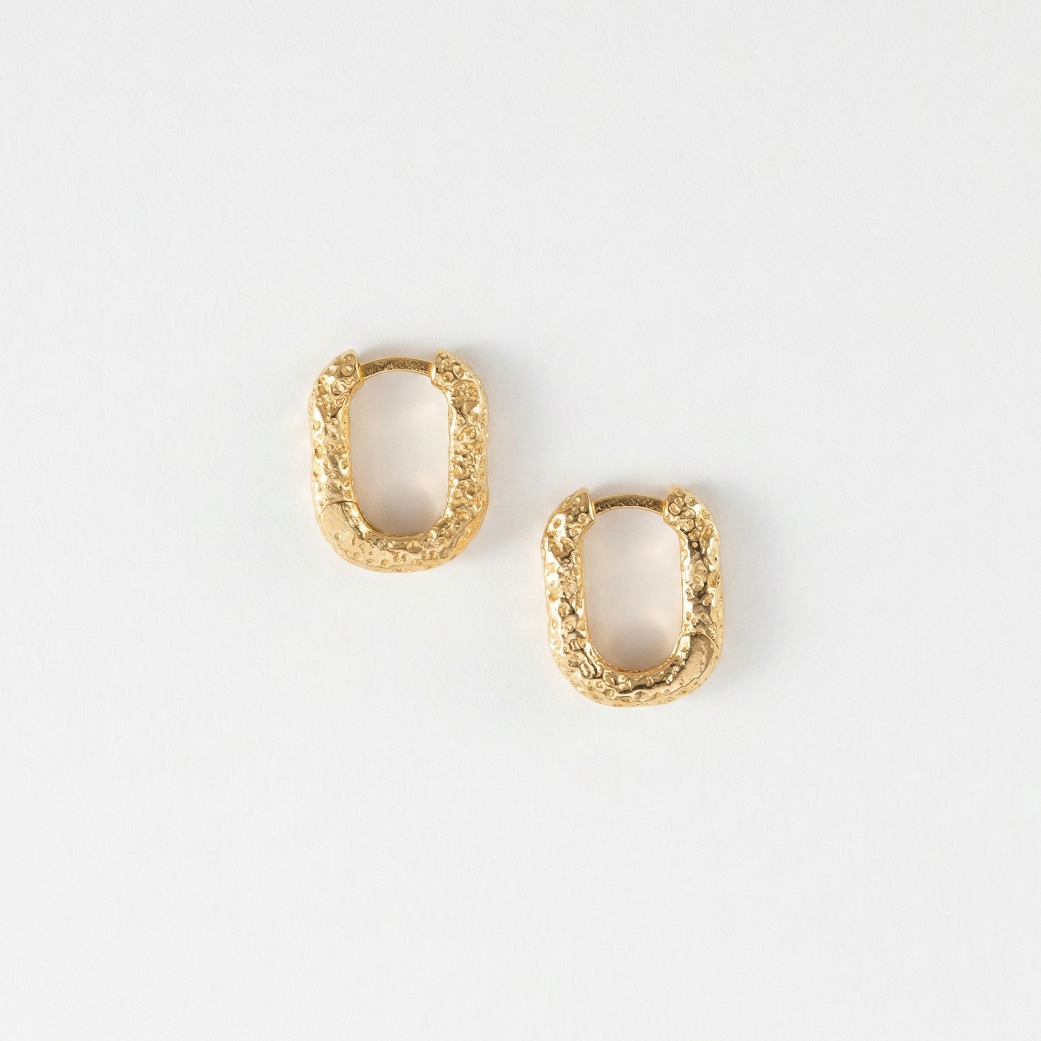 Gold-plated top-down view of textured gold hoops