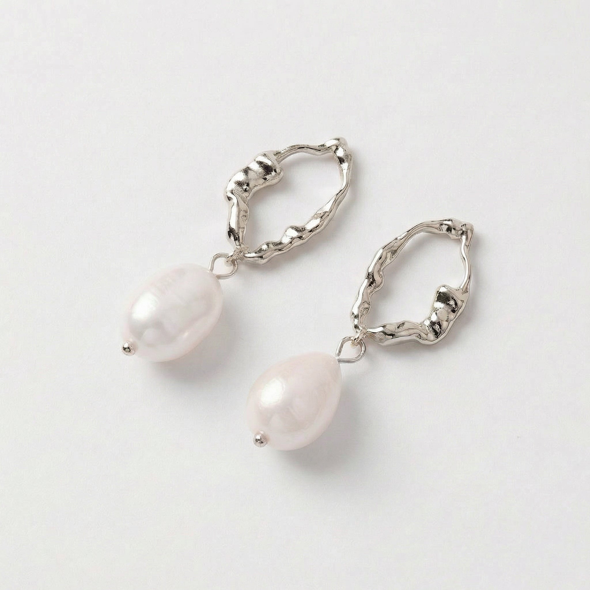 Silver top-down view of pearl drop earrings