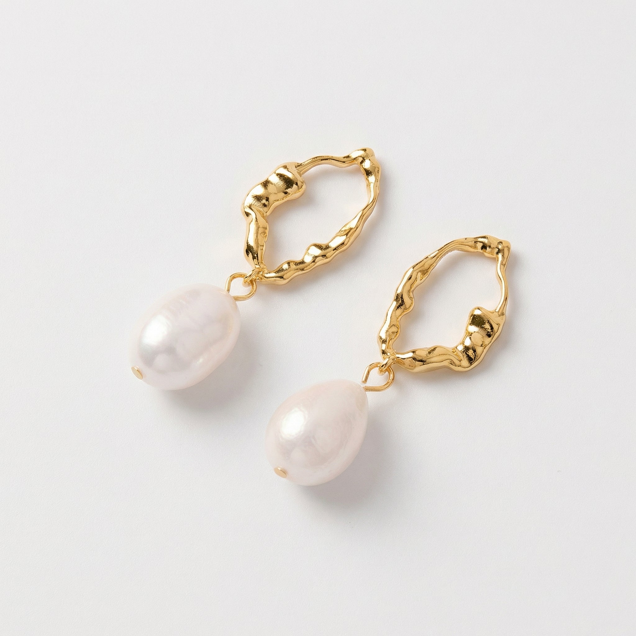 Gold-plated angled view of gold and pearl earrings