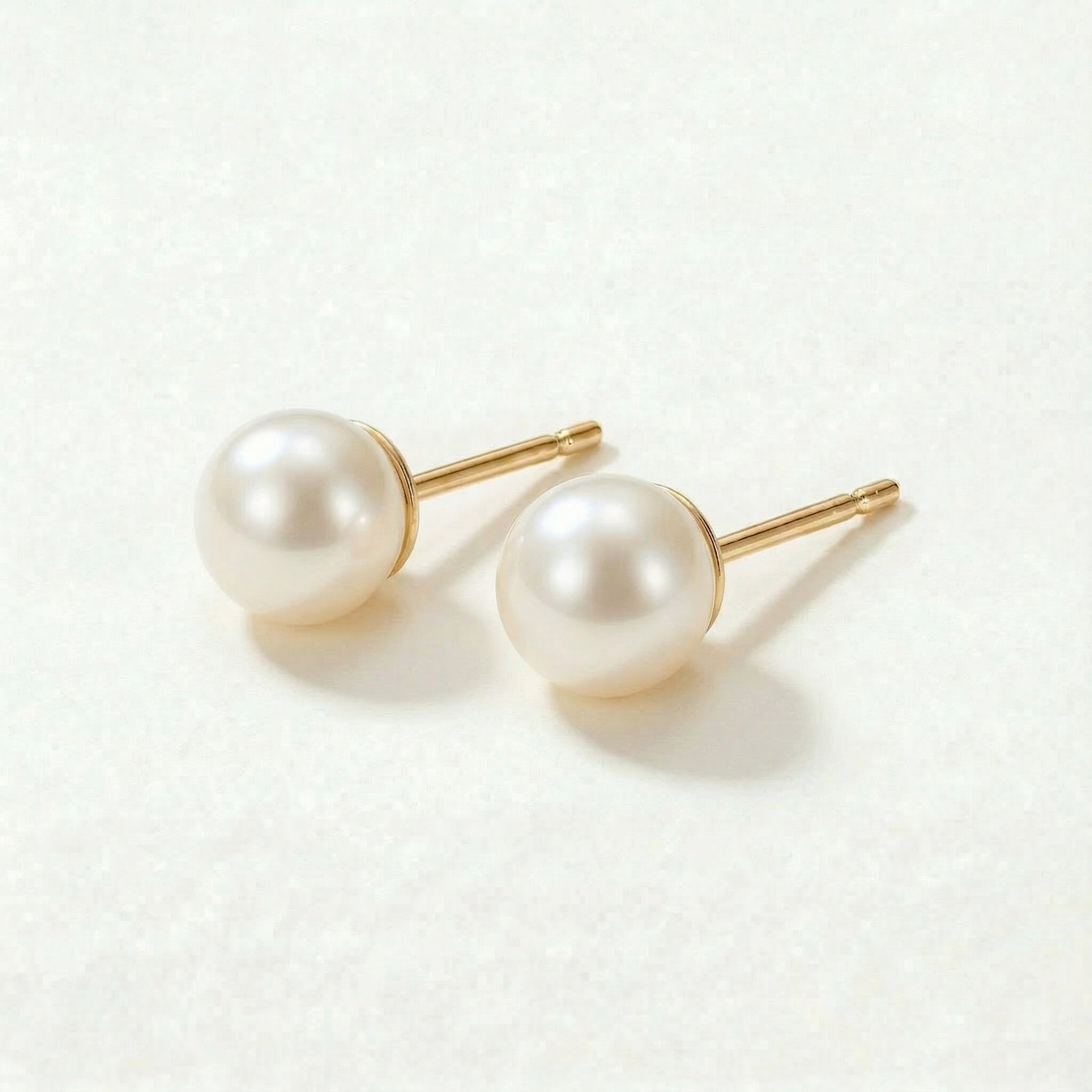 Gold-plated pearl stud earrings from an angle