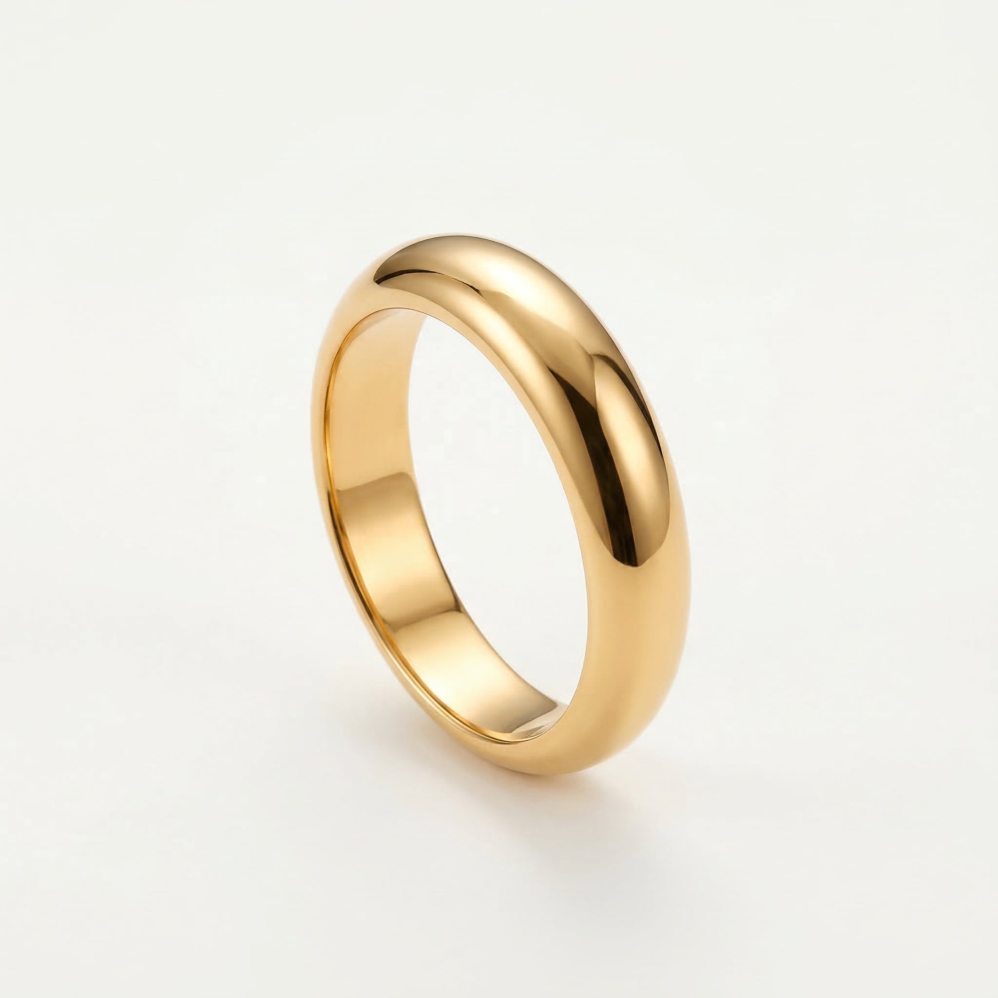 Gold-plated chunky ring on white background