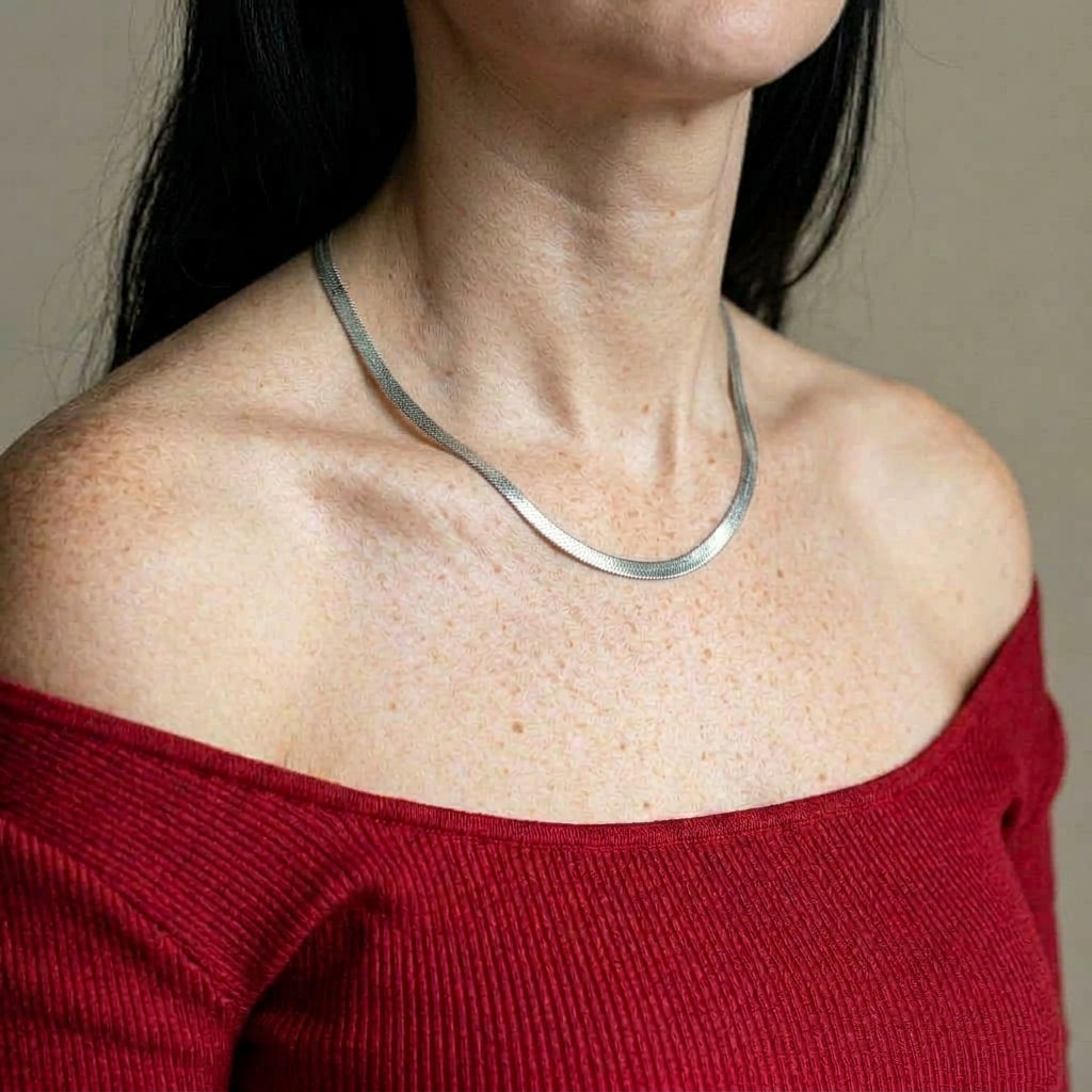 Silver necklace on model with red top