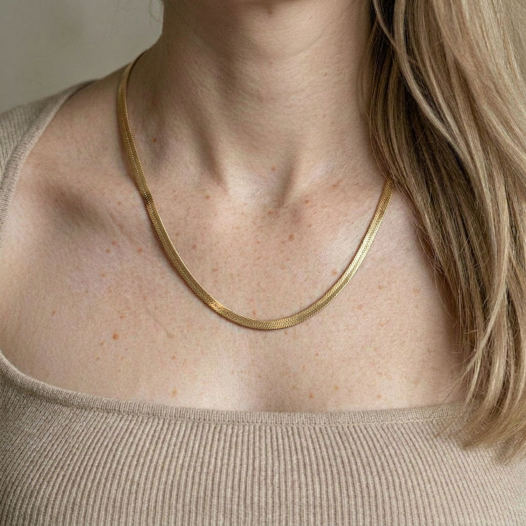 Gold-plated necklace worn on model's neck