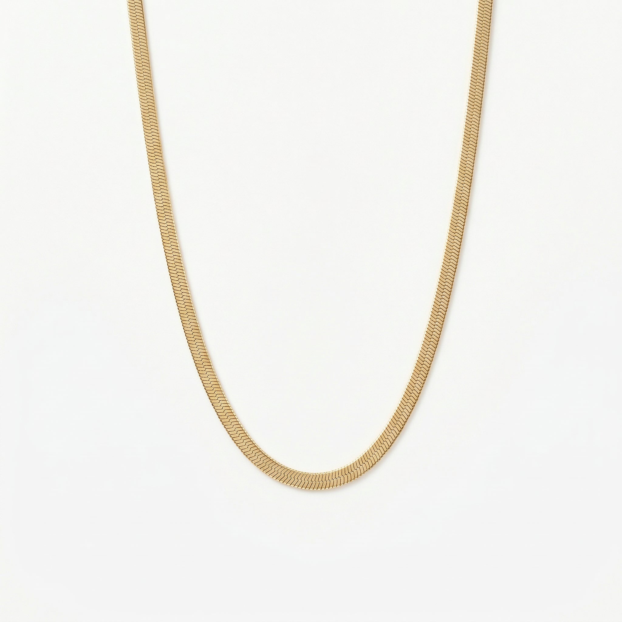 Gold-plated flat snake chain necklace on white