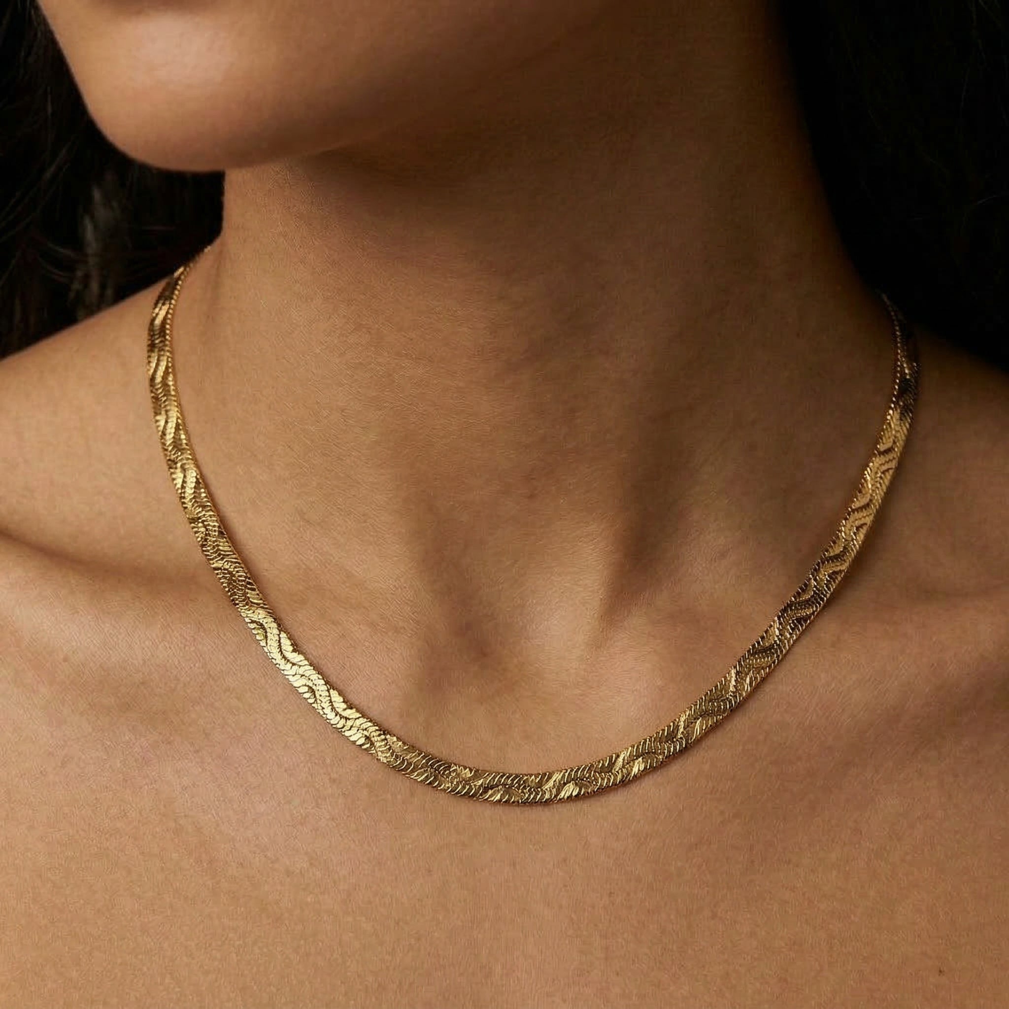 Gold-plated necklace worn on bare skin