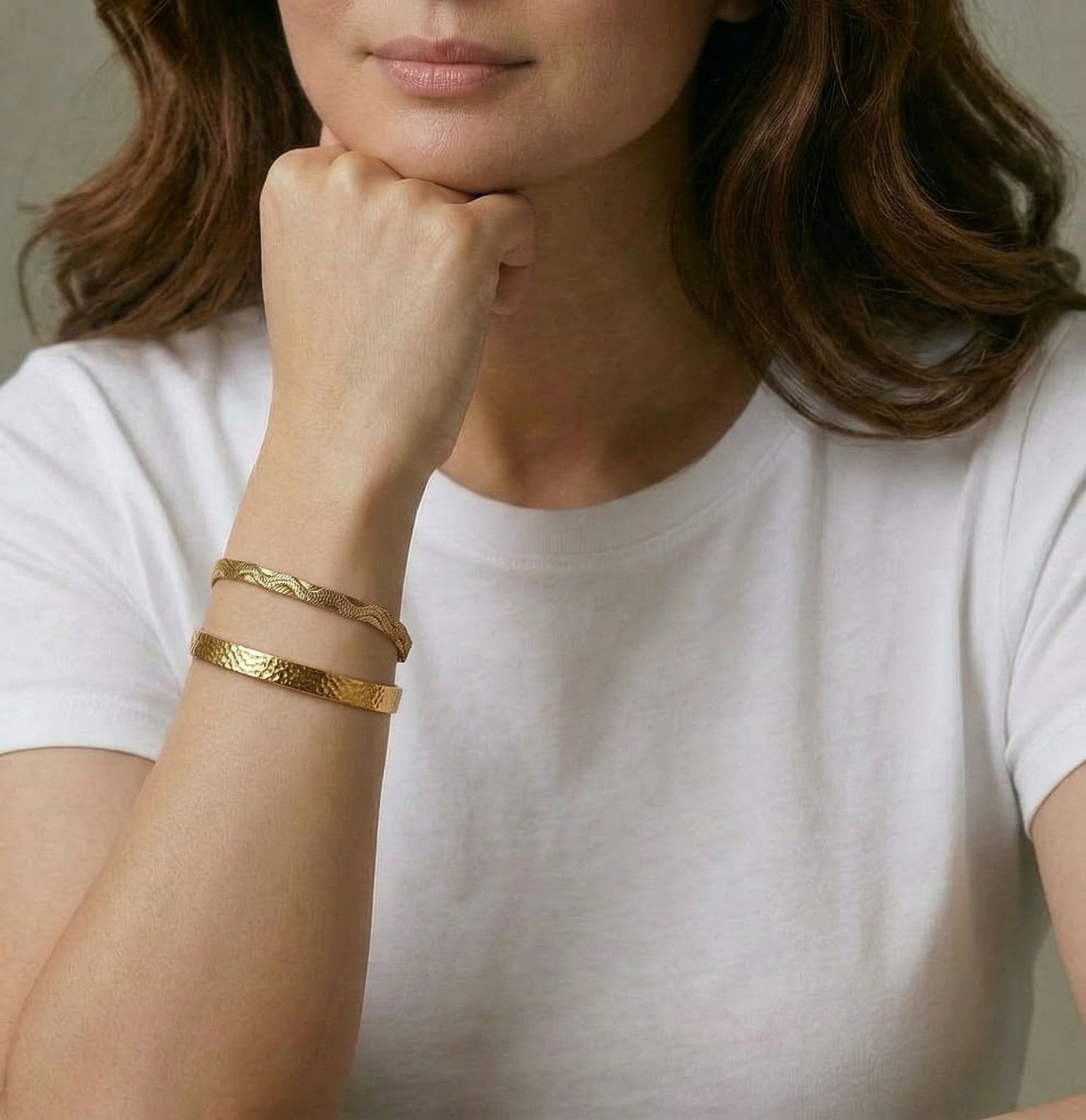 Gold-plated bangle worn with another bracelet