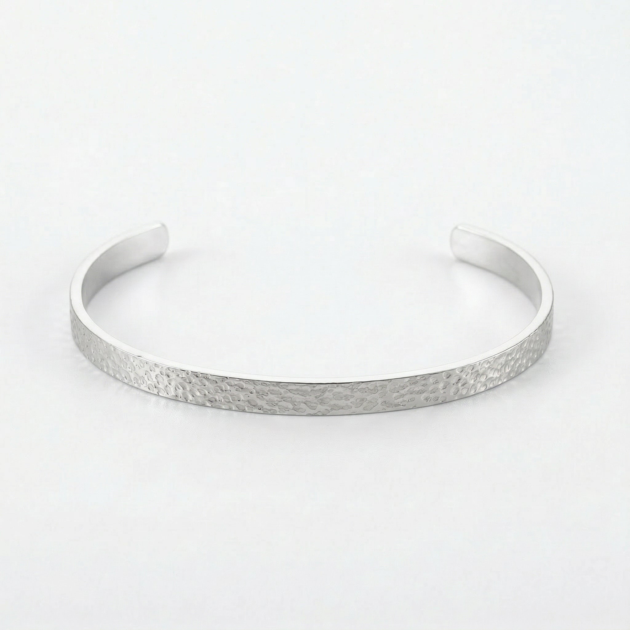 Silver hammered bangle on white background