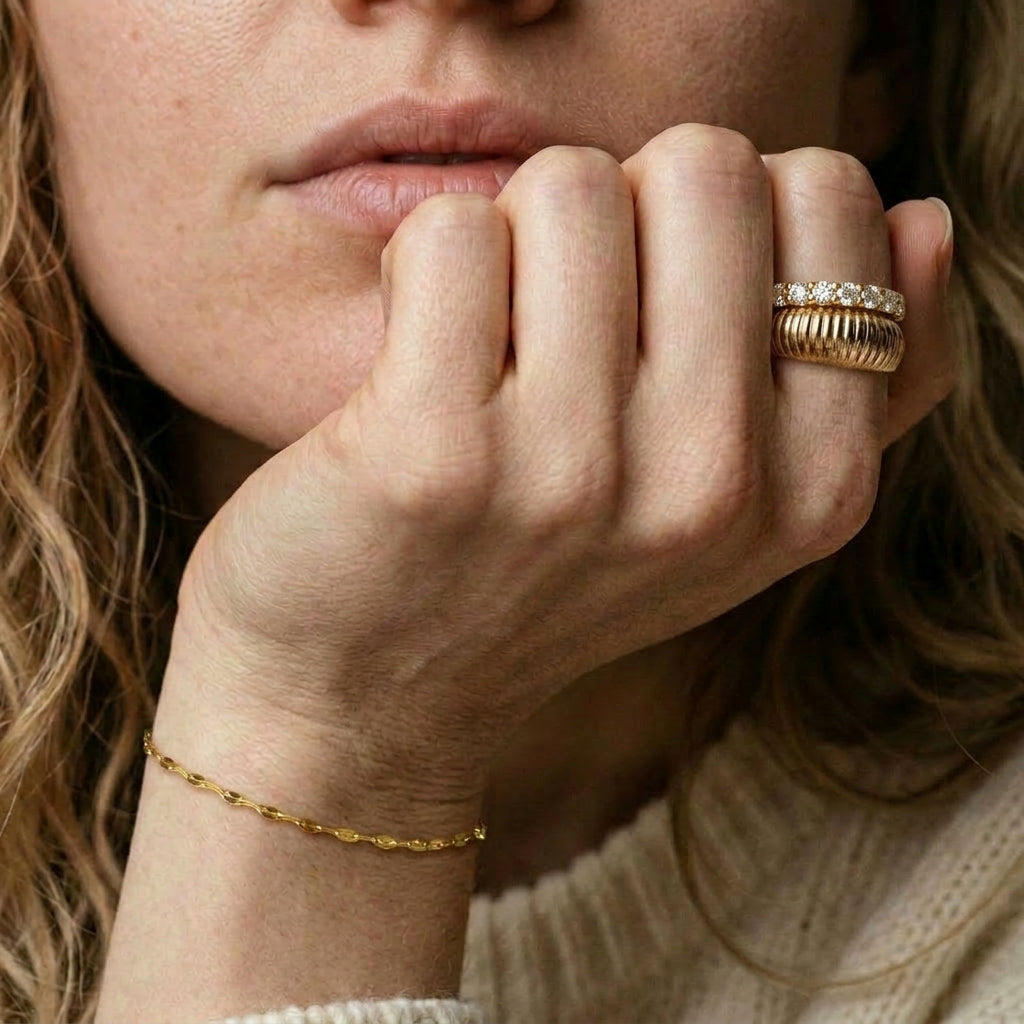 Gold-plated ring worn on hand with other jewelry
