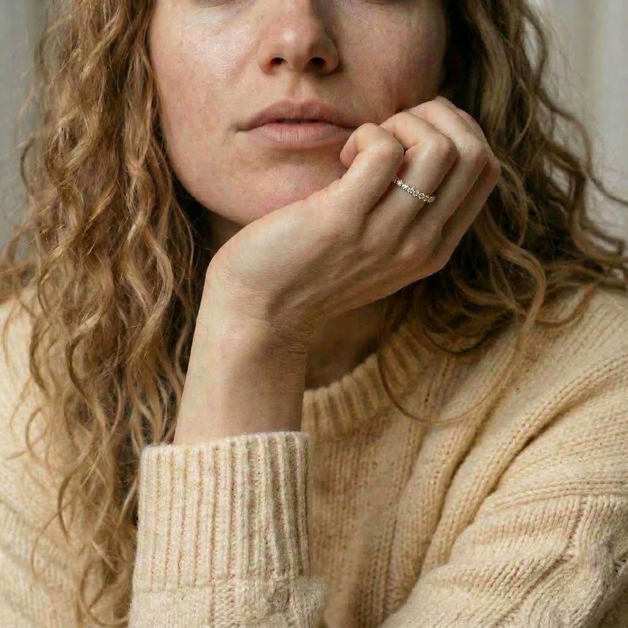 Gold-plated ring worn on model's hand and chin