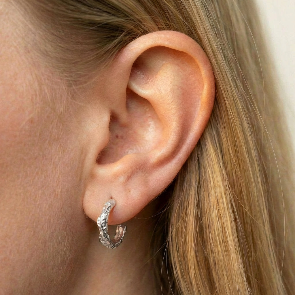 Hoop earrings silver close-up of earring on ear