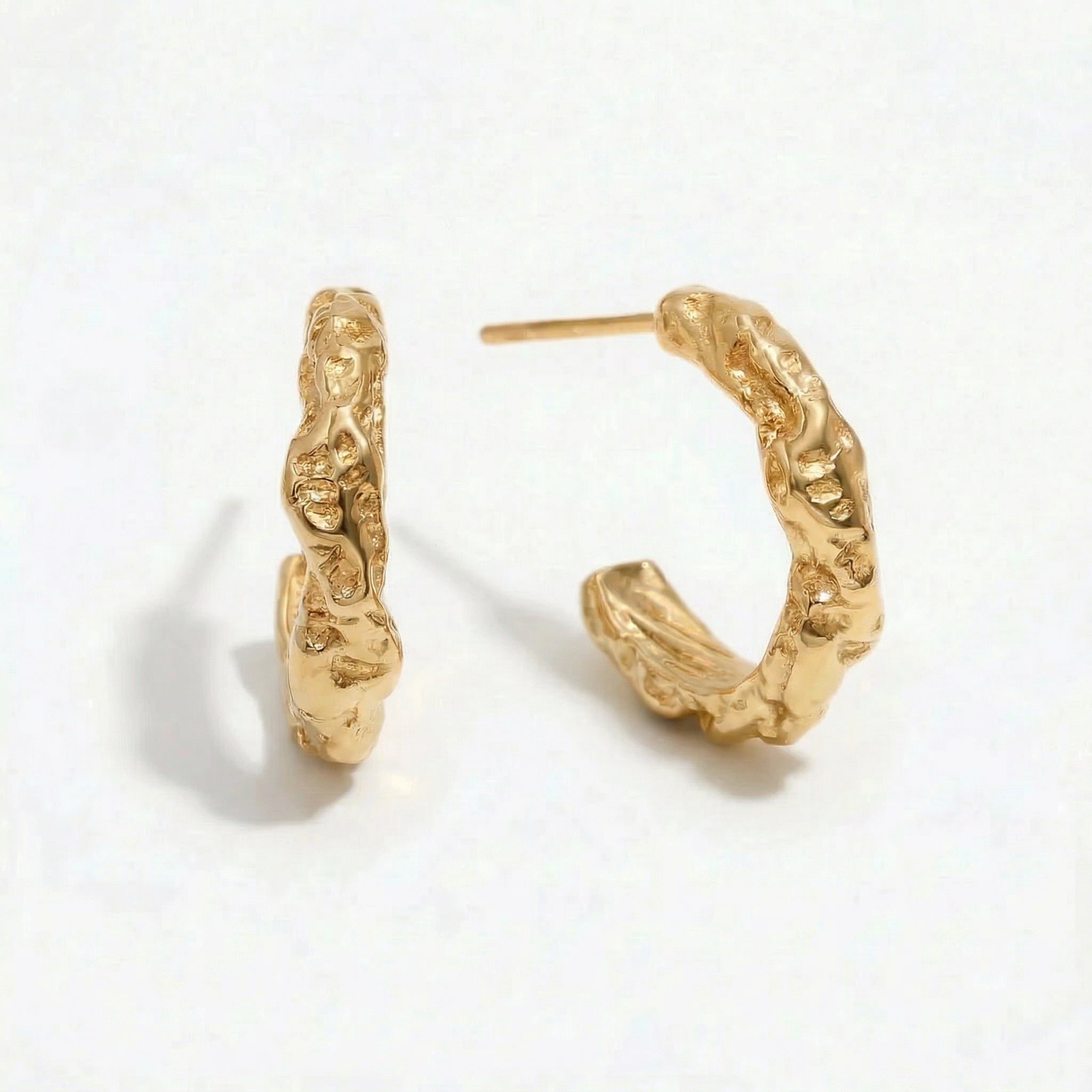 Gold-plated molten gold hoop earrings on white background