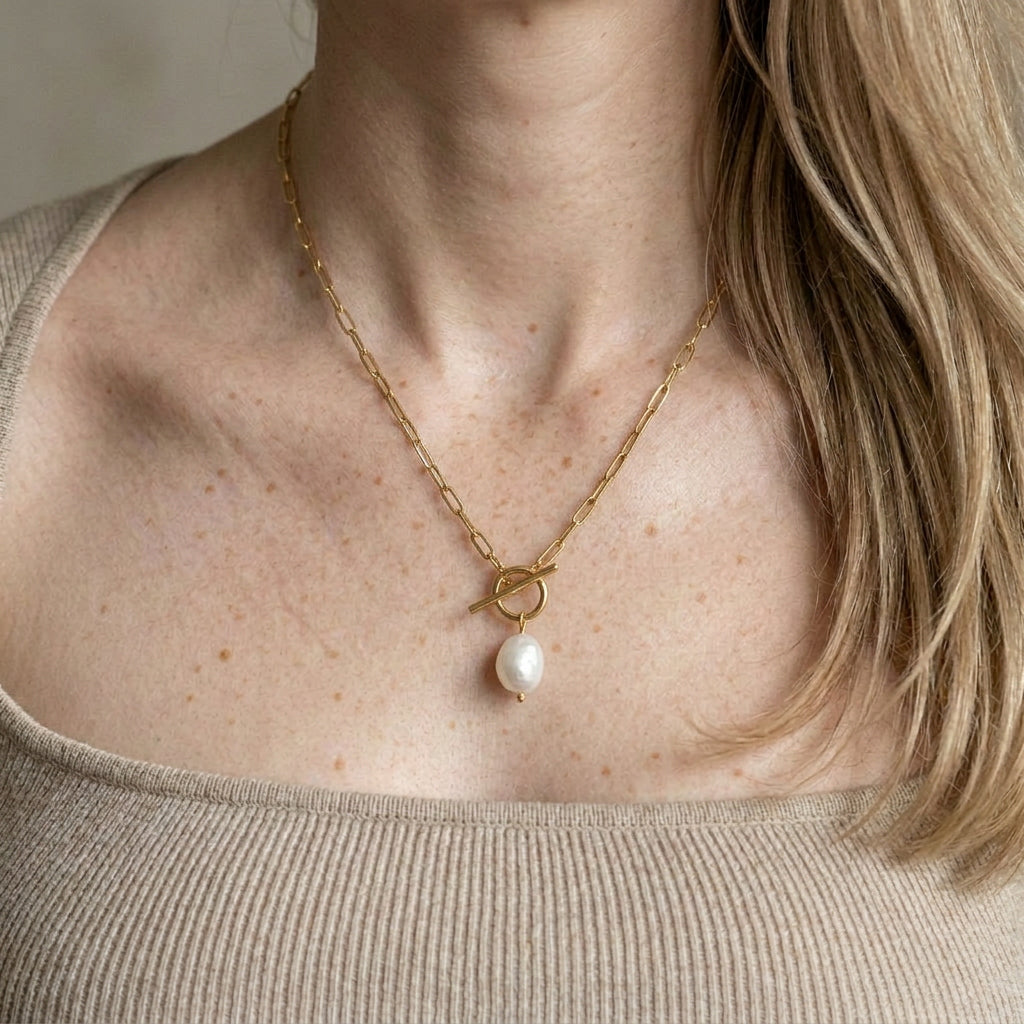 Gold-plated necklace worn on model with freckles