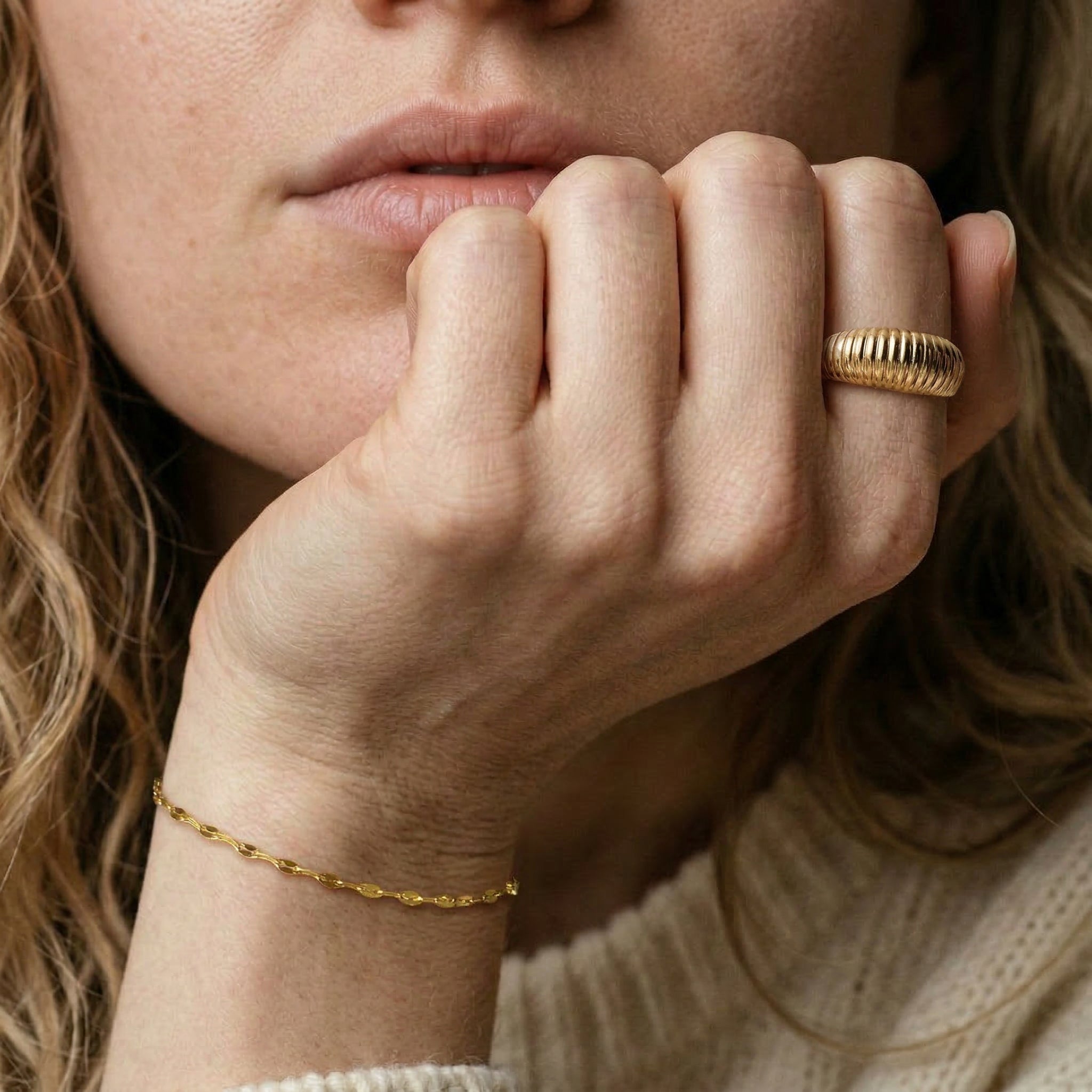 Gold-plated bracelet worn on model's wrist
