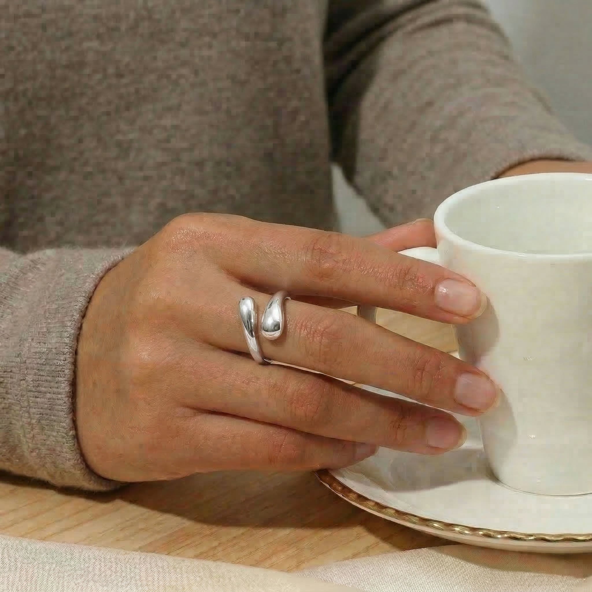 Silver ring worn while holding coffee cup