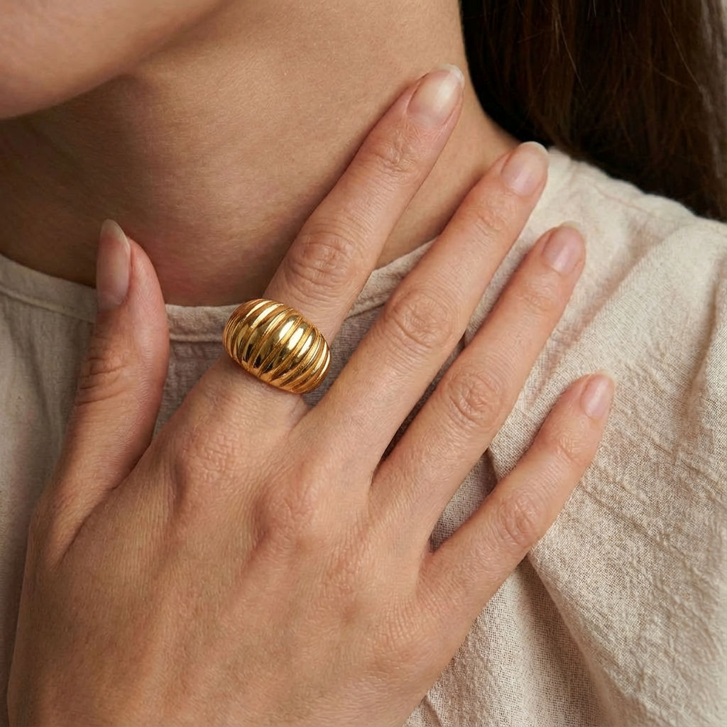 Gold-plated ring worn on hand, close-up